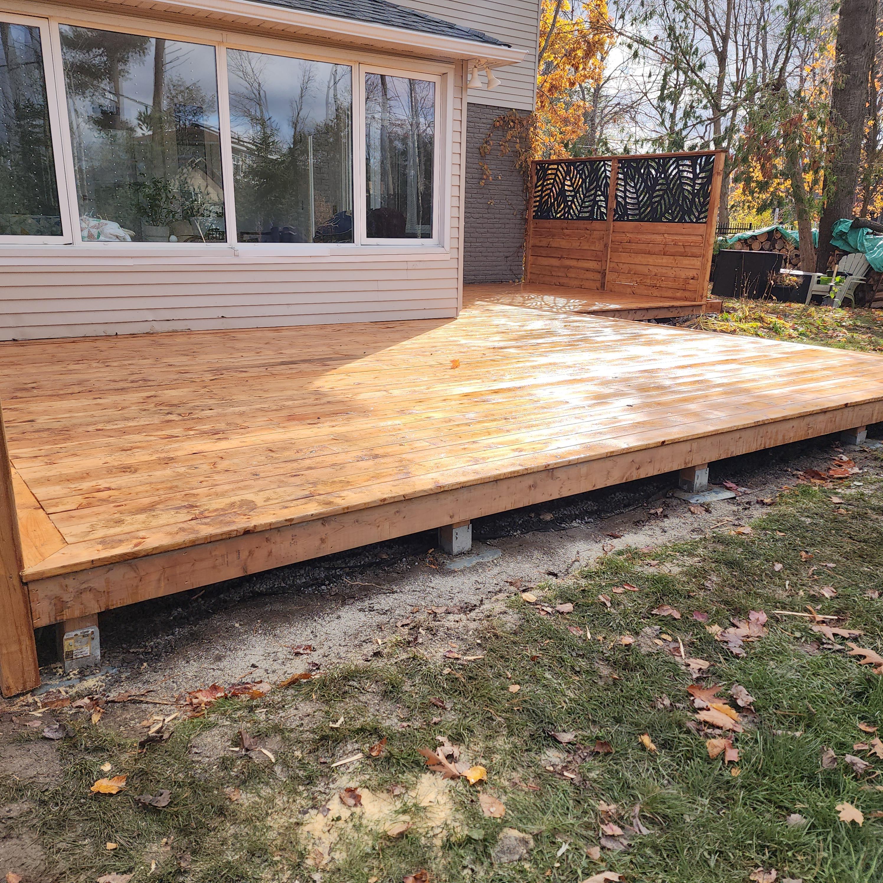 photo of a low level deck with privacy wall in the background