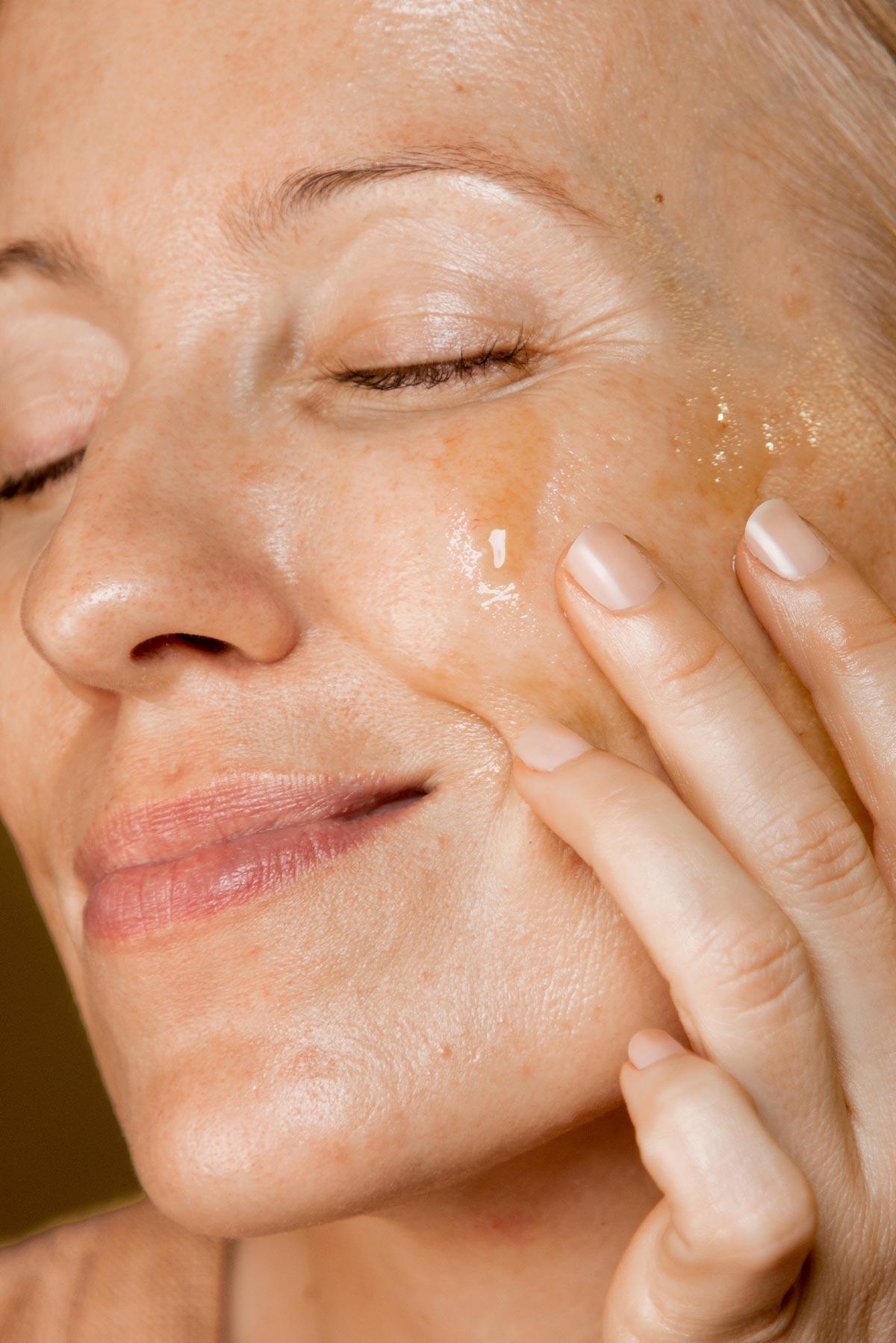 a woman applying oil