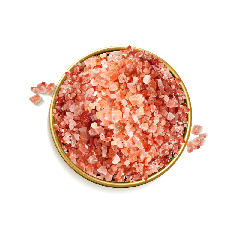 A bowl of Himalayan rock salt surrounded by floral artworks