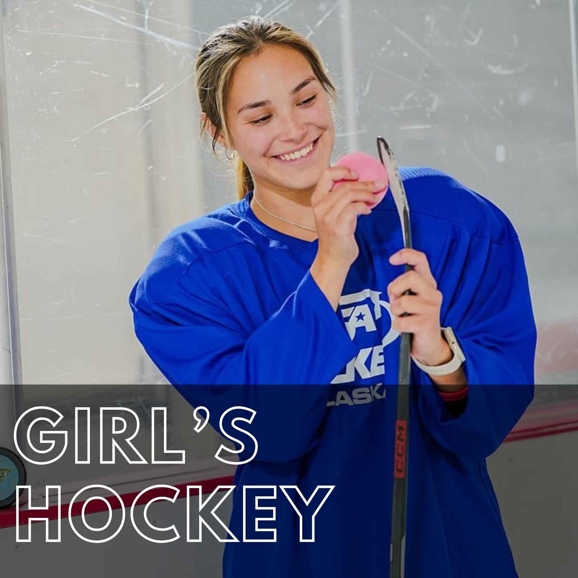 irls hockey player holding a stick and pink hockey wax at the rink. Girl's Hockey