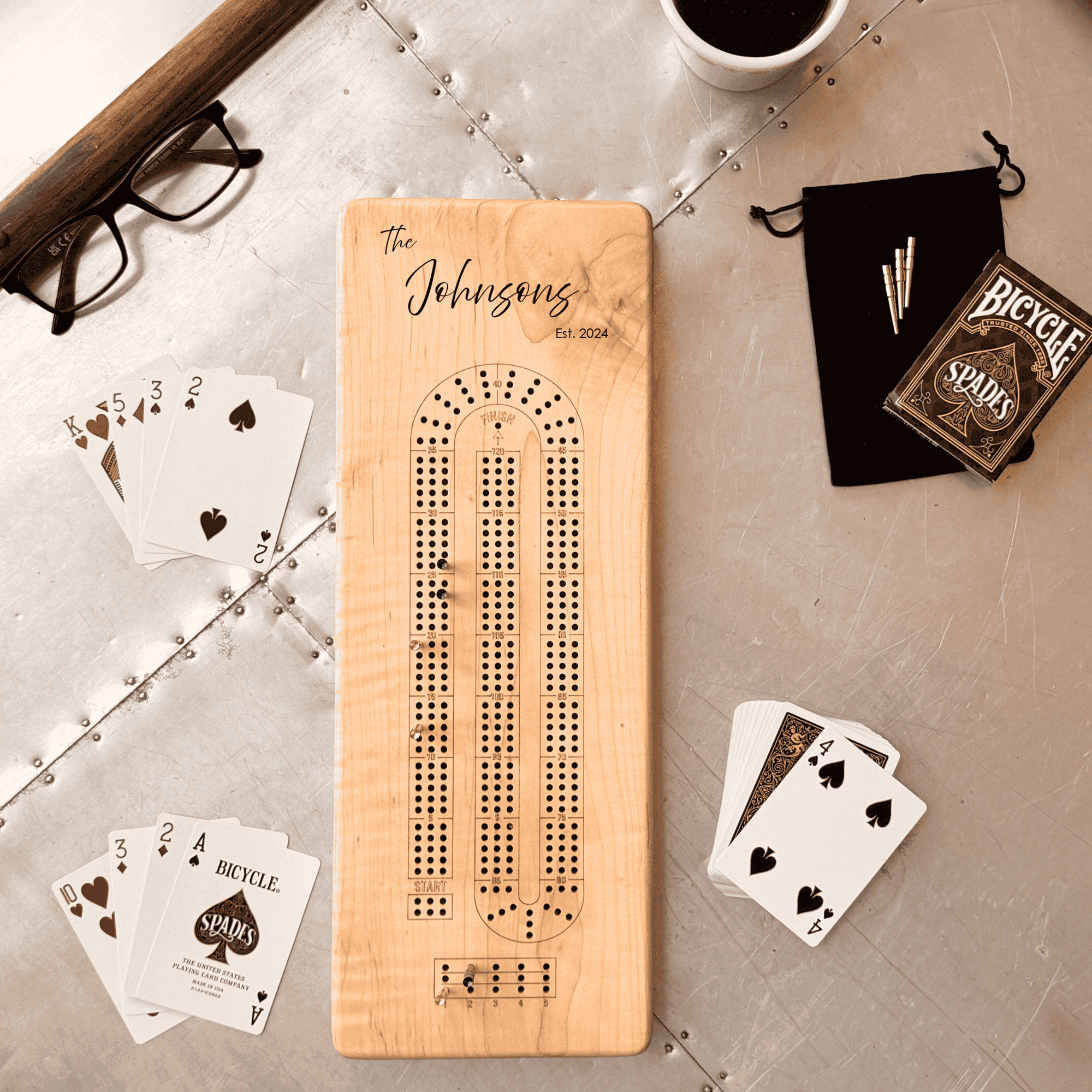 Personalized straight edge wood cribbage board with clean design and playing cards on table