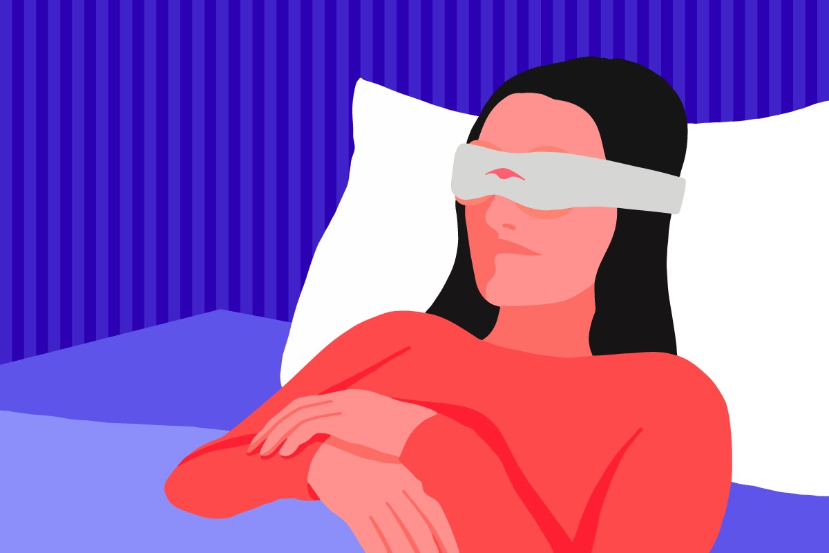 A girl relaxing in bed while wearing a therapeutic sleep mask.