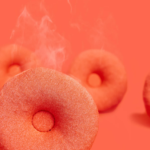 Three orange warming eye cups for a sleep mask emitting steam.