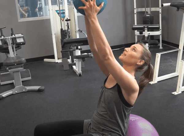 Fit Lady Exercising in Gym on Fitness Ball