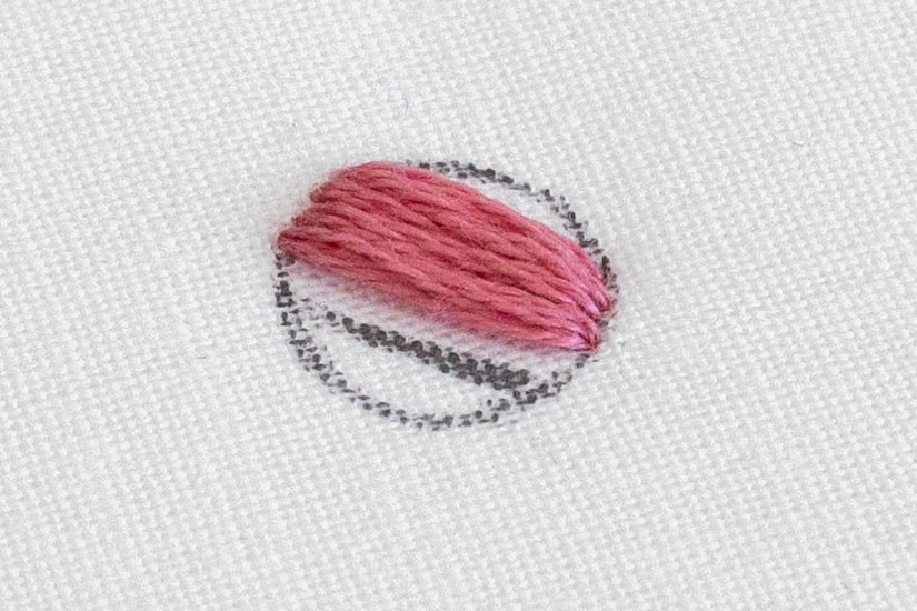 An area of satin stitch has been made up in a circle.