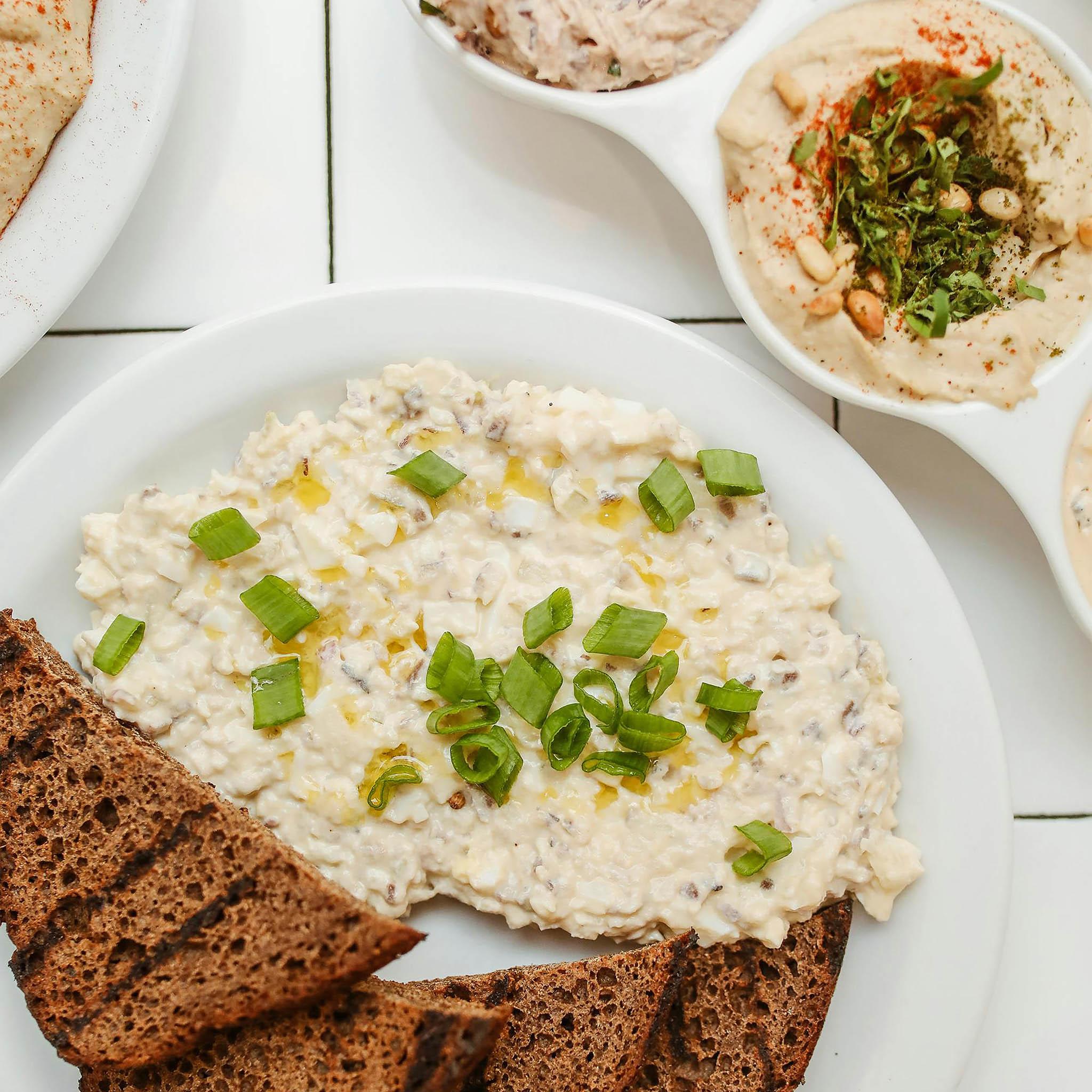 Healthy meal planning layout with prepared food and ingredients on a white surface