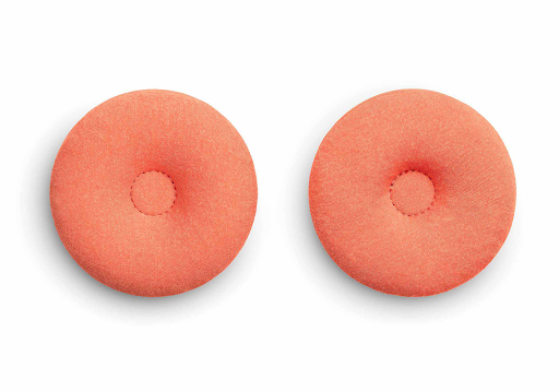 A pair of round orange eye cups for a heated sleep mask with an indentation in each center.