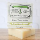 Picture of a box of Shart Wash Natural Handmade Bar Soap Hawaiian Pooau scent sitting on a light yellow bar of soap with a wood background