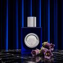 Venetian Belladonna bottle with purple belladonna flowers against a pleated curtain