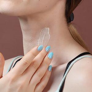 A woman applying Cerabuild on her neck