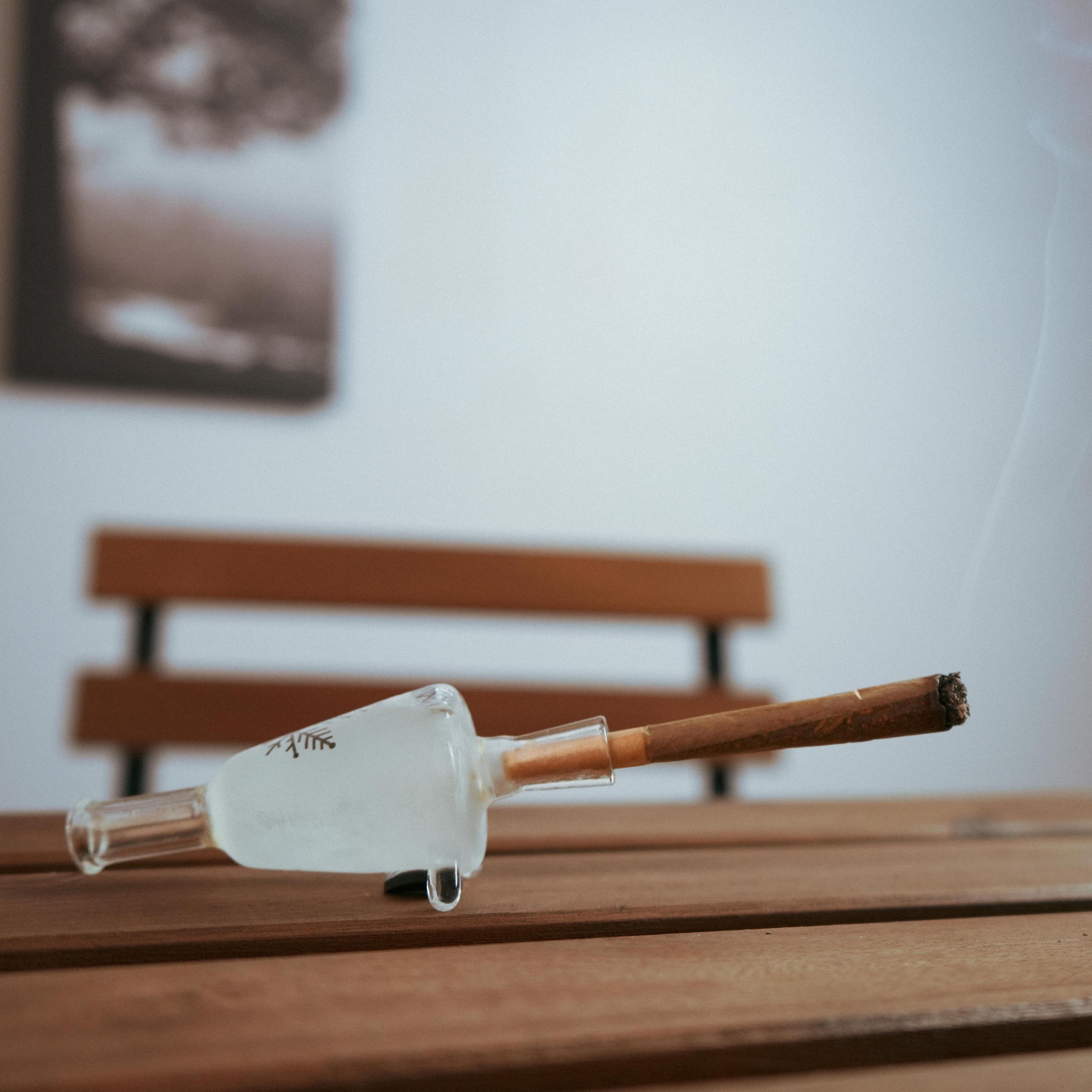 glass joint holder with smoking joint in it