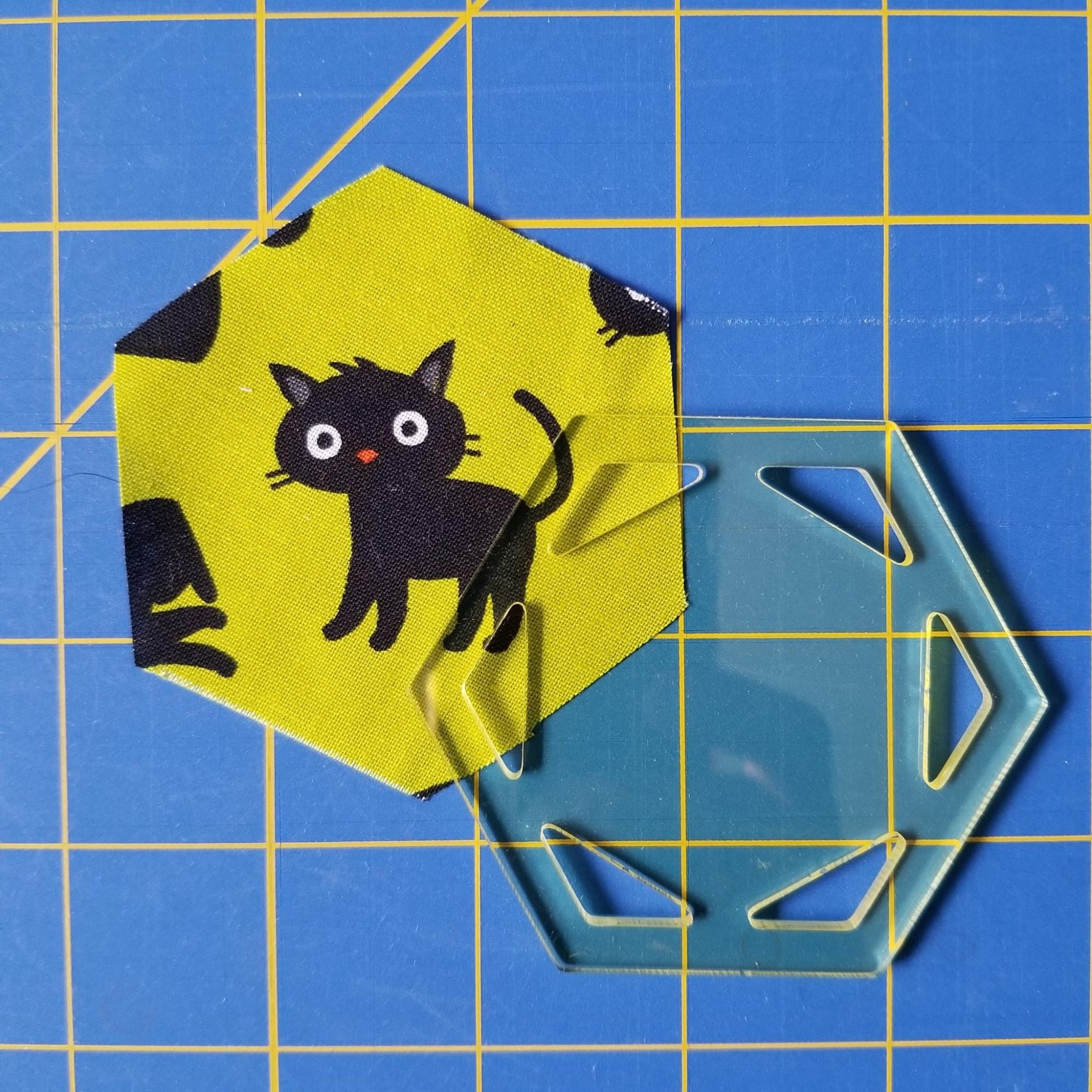 Showing a fussy cut, fabric hexagon that was made by using a hexagon quilt template.