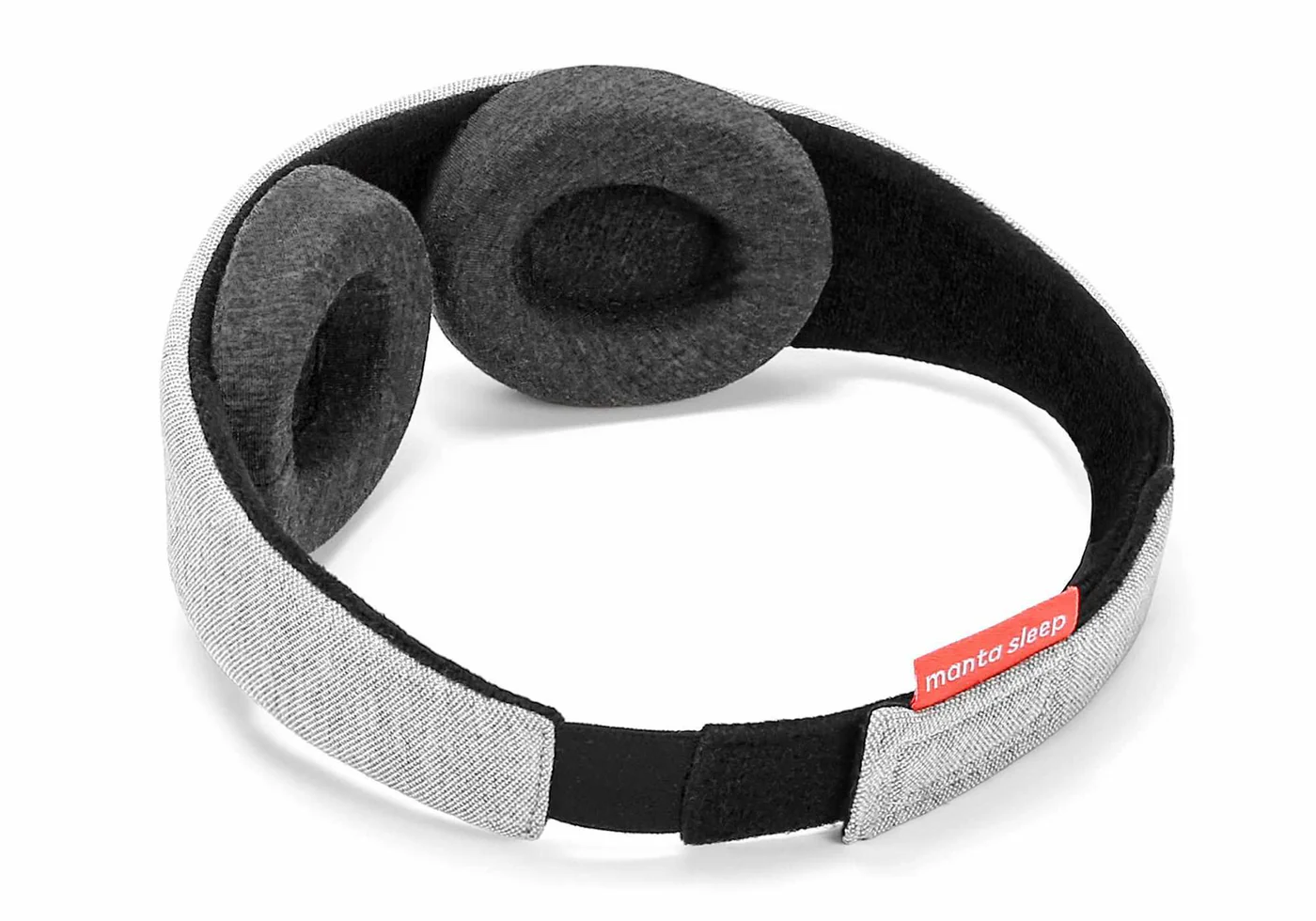 Dark gray convex eye cups attached to the black interior of a sleep mask.