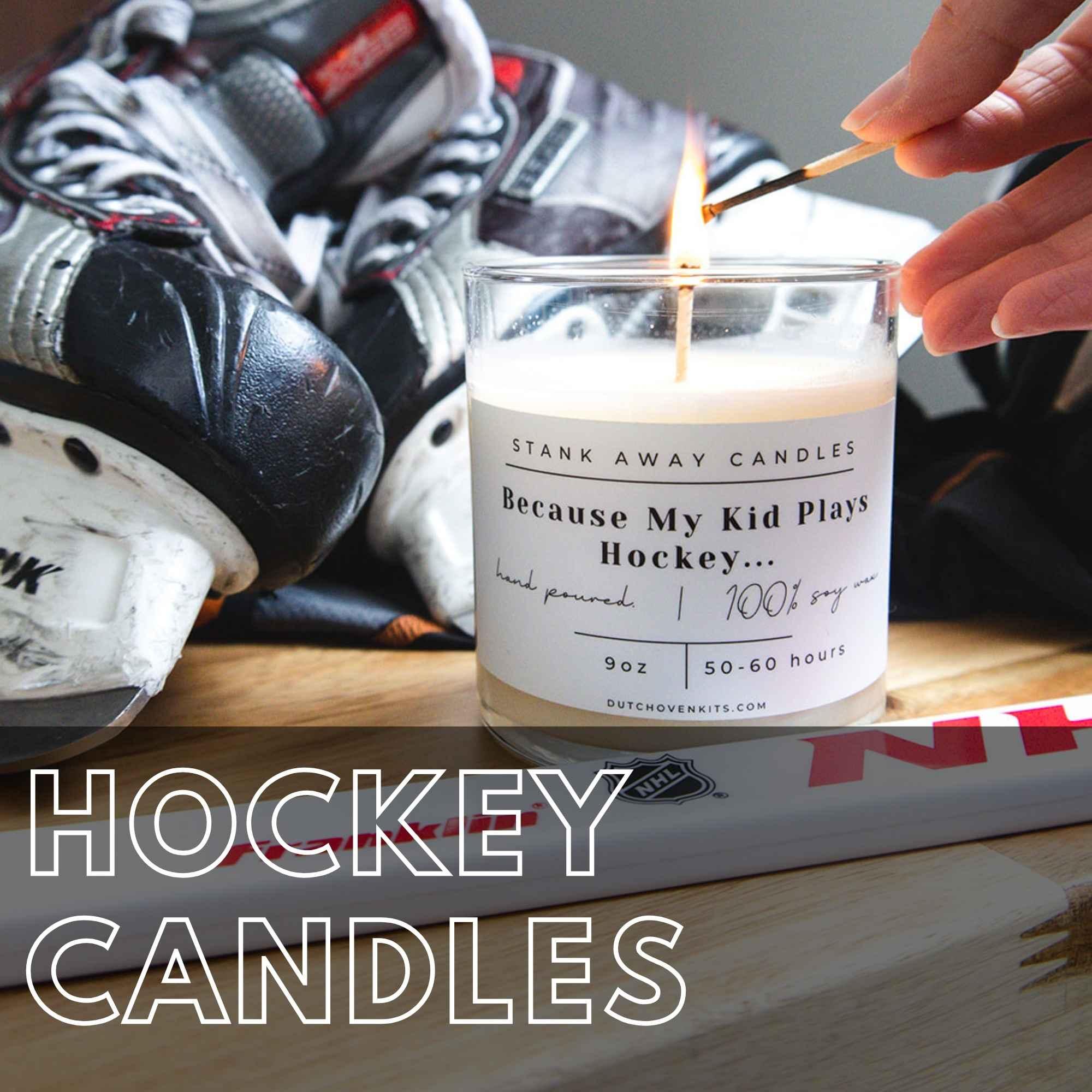 Hockey candle burning beside skates and a hockey stick in a locker room setting. Hockey Candles