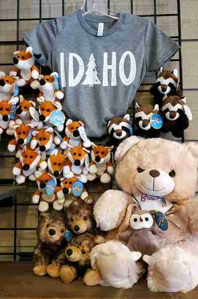 A t-shirt hanging with a bunch of stuffed animals