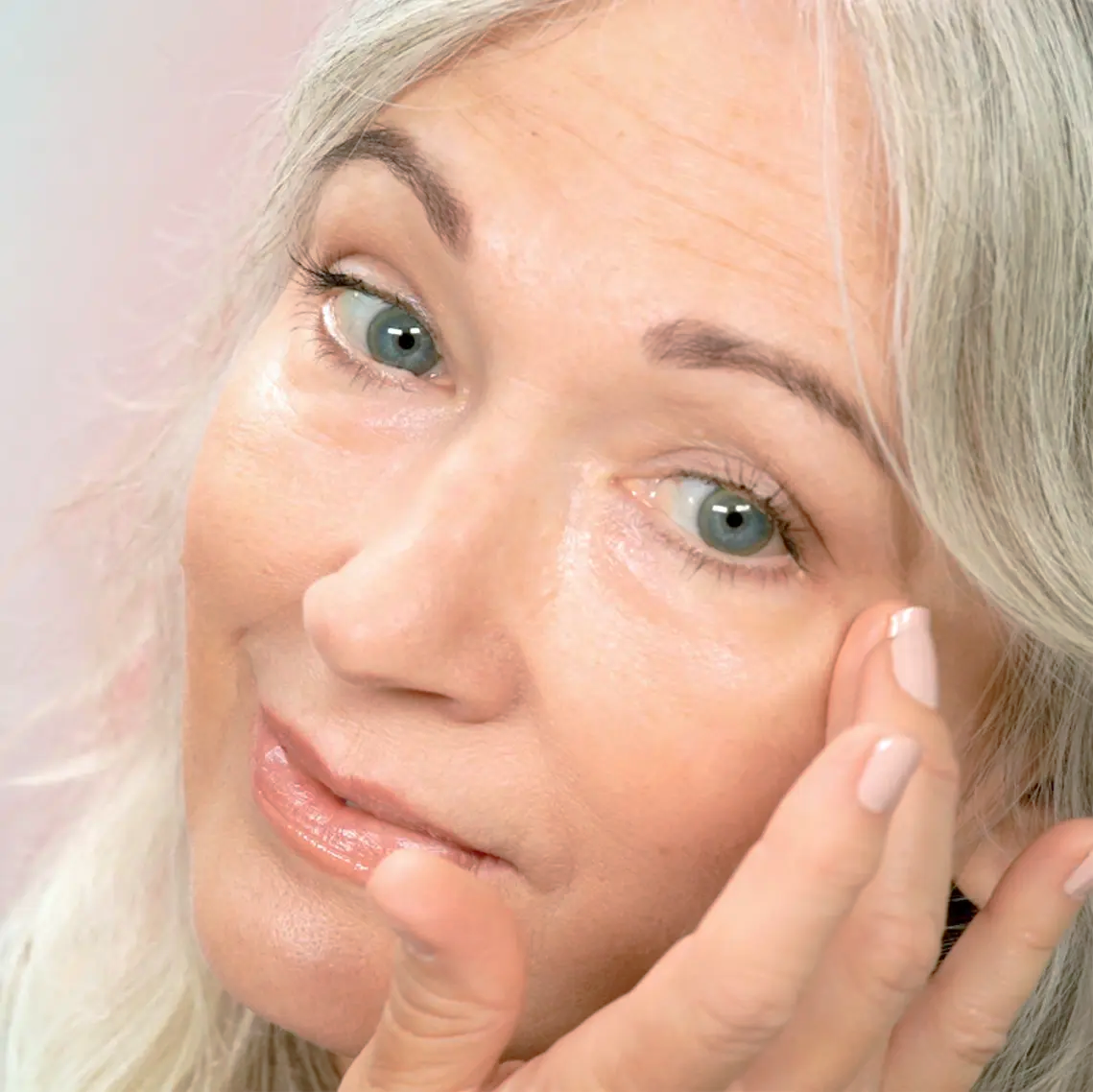 Women massaging under eyes