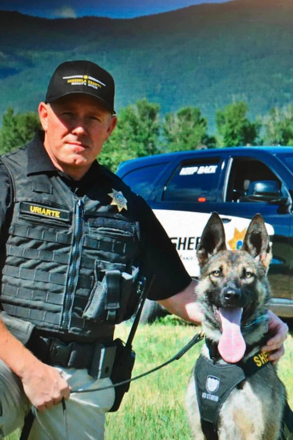 K9 santxo and handler with sheriff's car