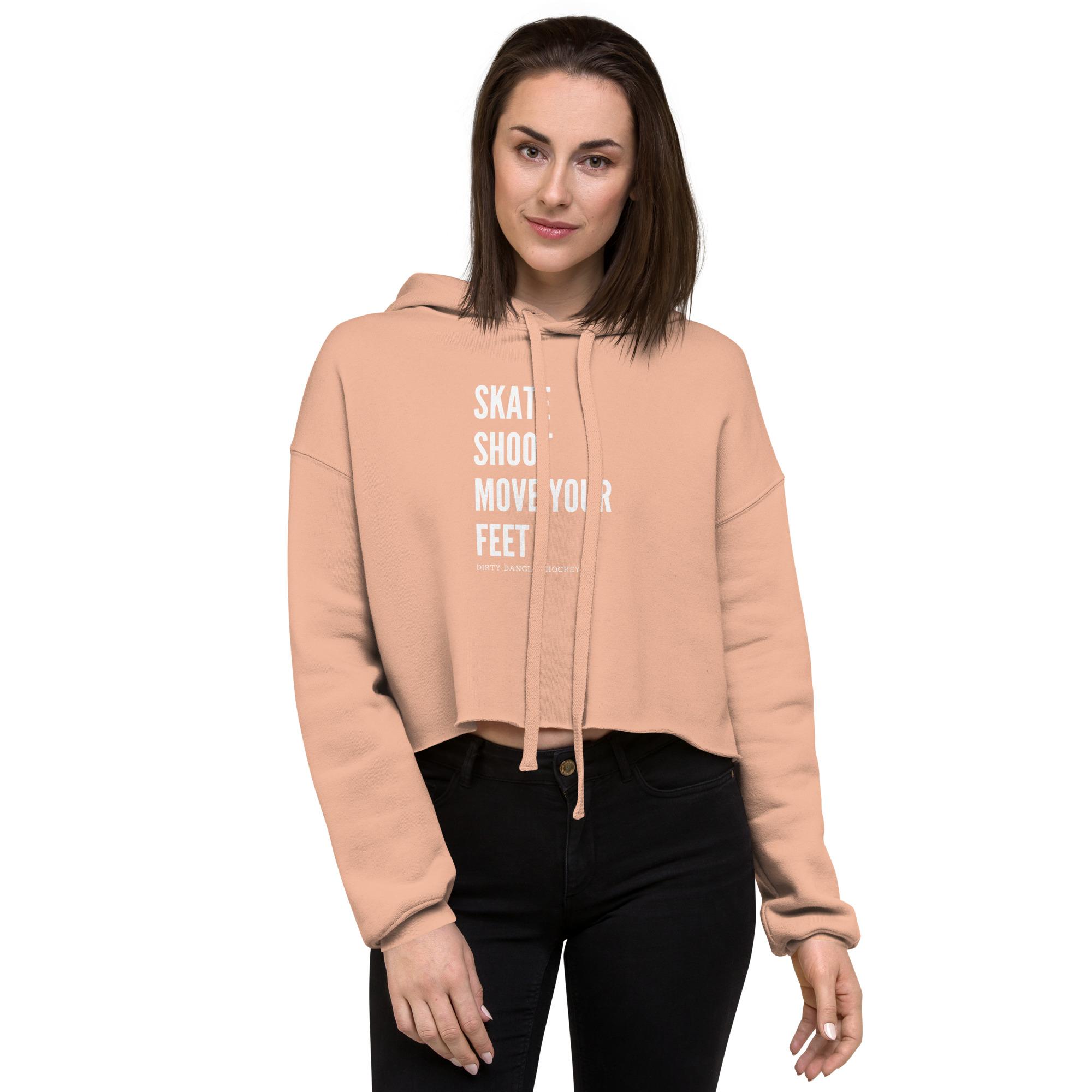 a hockey mom in a pink crop hoodie. Skate shoot move your feet.