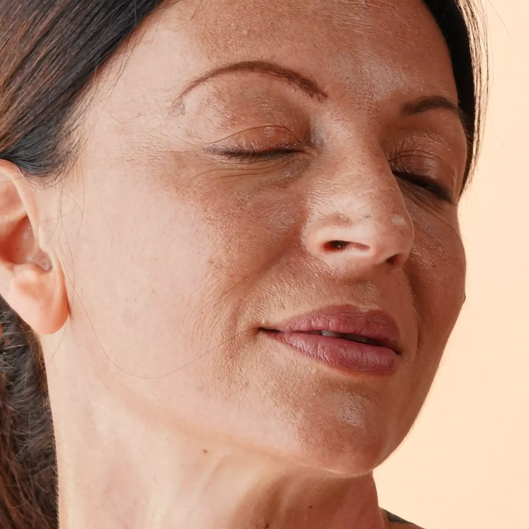 A woman cleaning her face