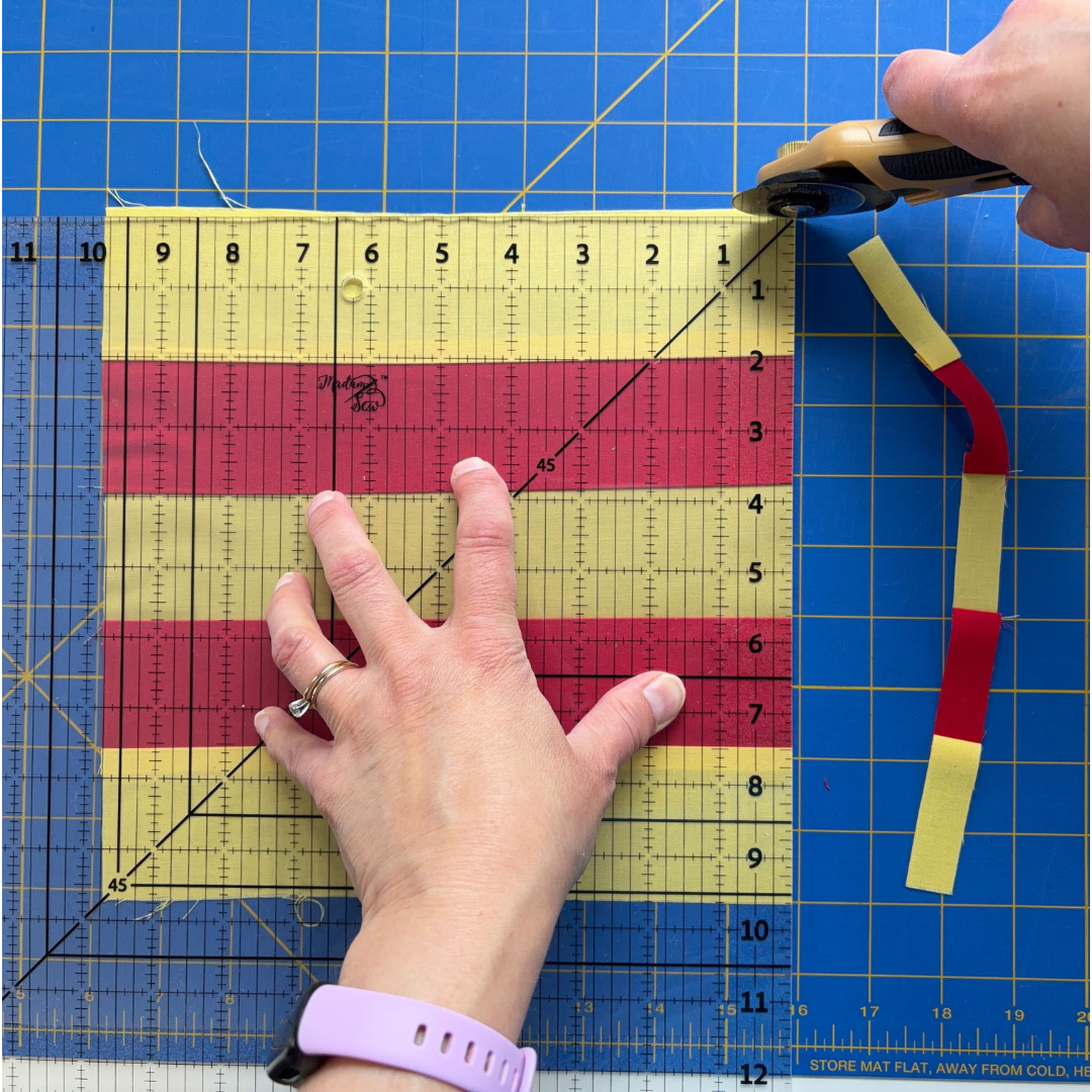 Trimming excess fabric on the top edge of the square-up ruler.