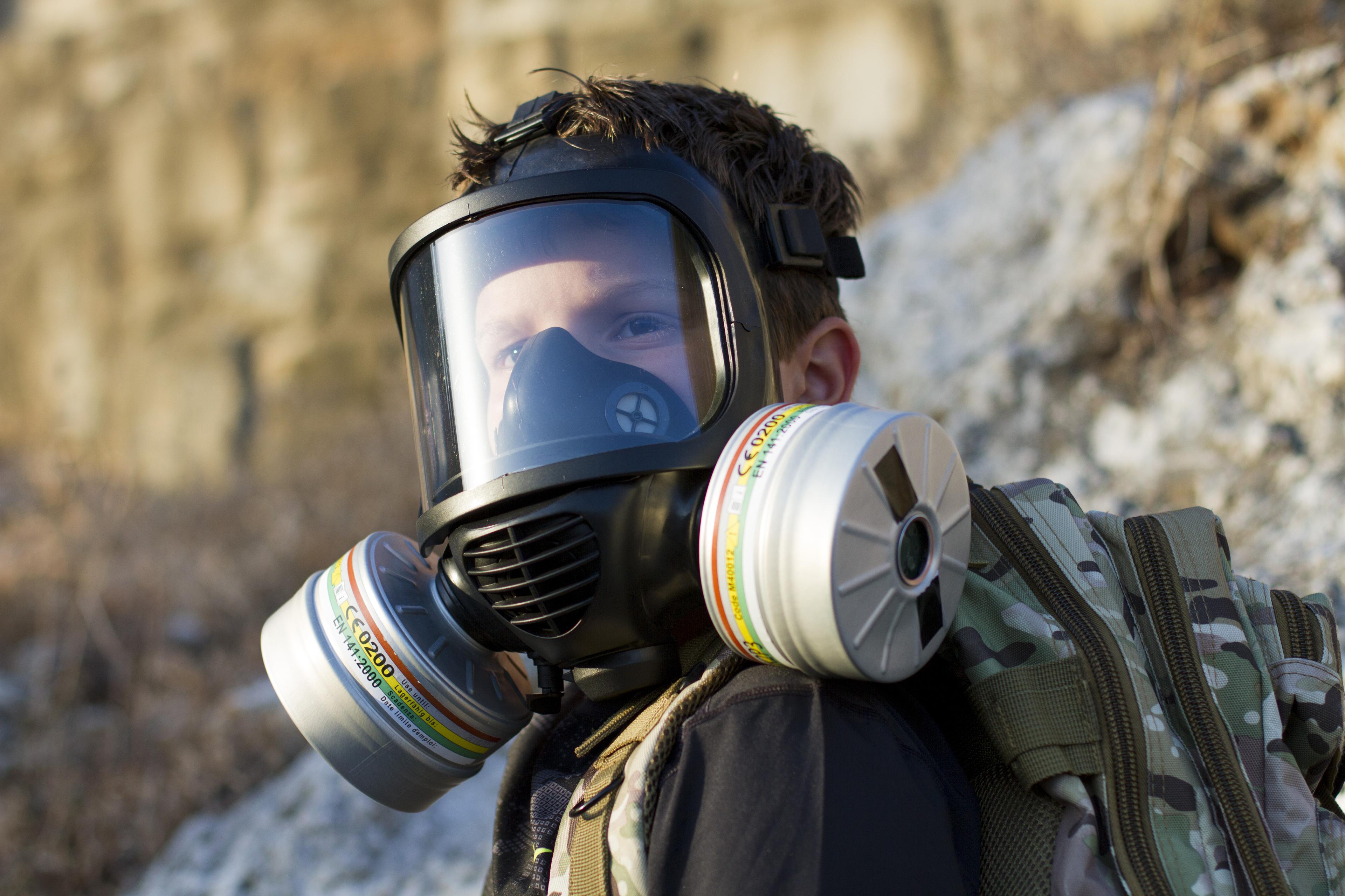 Survivalist man wearing Mira Safety gas mask