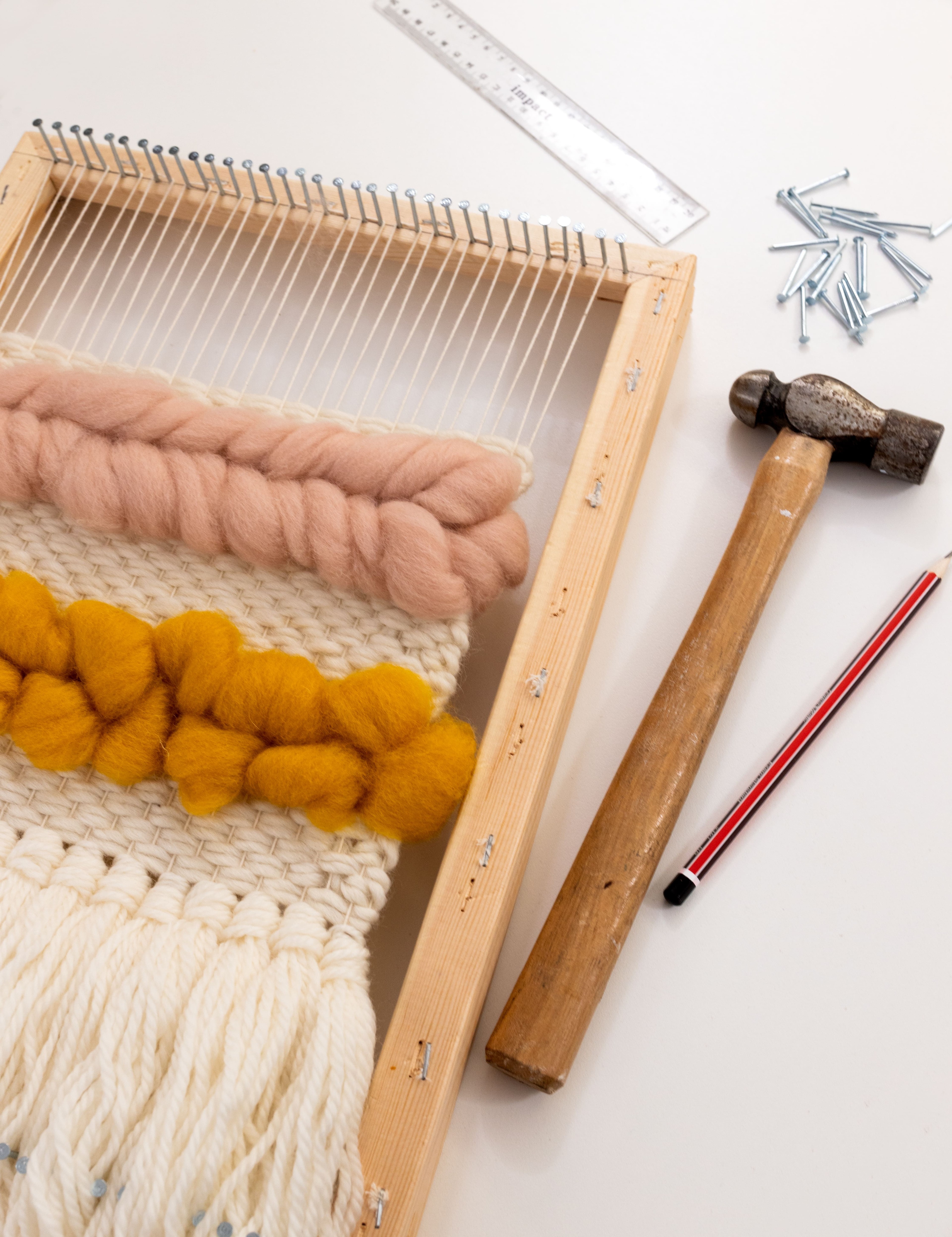 This is an image of a DIY frame loom and the supplies needed to make it.