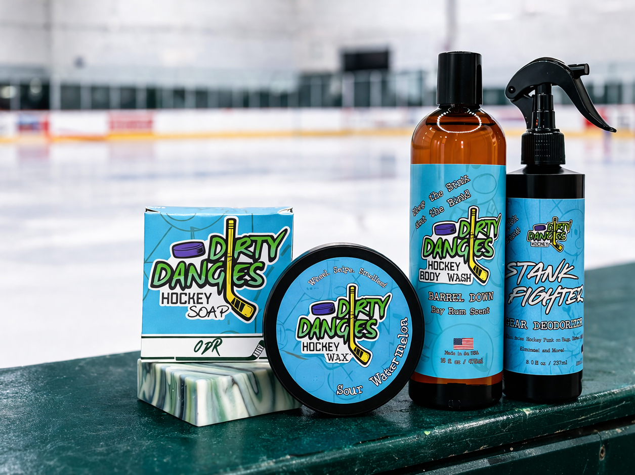 Dirty Dangles hockey soap, stick wax, body wash and gear deodorizer displayed on rink boards