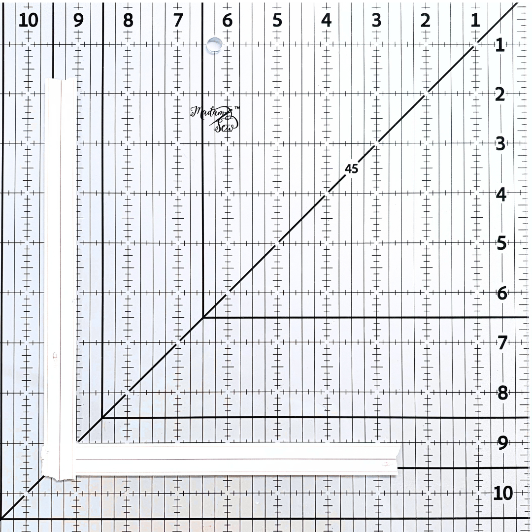 Picture showing two pieces of washi tape, one with the right edge on the vertical 9” line of the Madam Sew 12.5” Square-Up Quilting Ruler. The other on the horizontal 9” line. Both pieces of washi tape cross where the 9” lines meet.