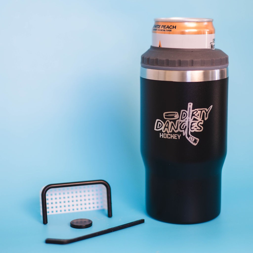 A black dirty dangles 2 in 1 drink tumbler can cooler on a blue background with a tiny hockey stick and net