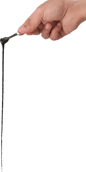 Shilajit resin dripping from a spoon
