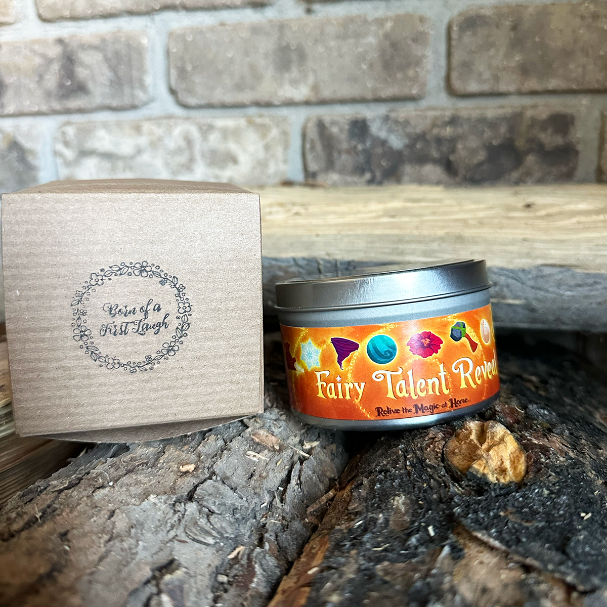 Fairy Talent Reveal Candle on top of some wooden logs next to a gift box.