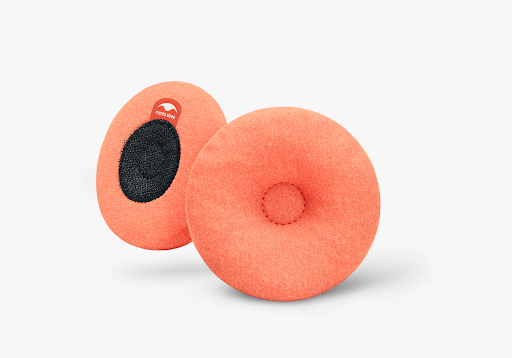 Two orange warming eye cups for a sleep mask. One cup shows the micro hook and loop closure backing. The other cup has an indentation at its center.