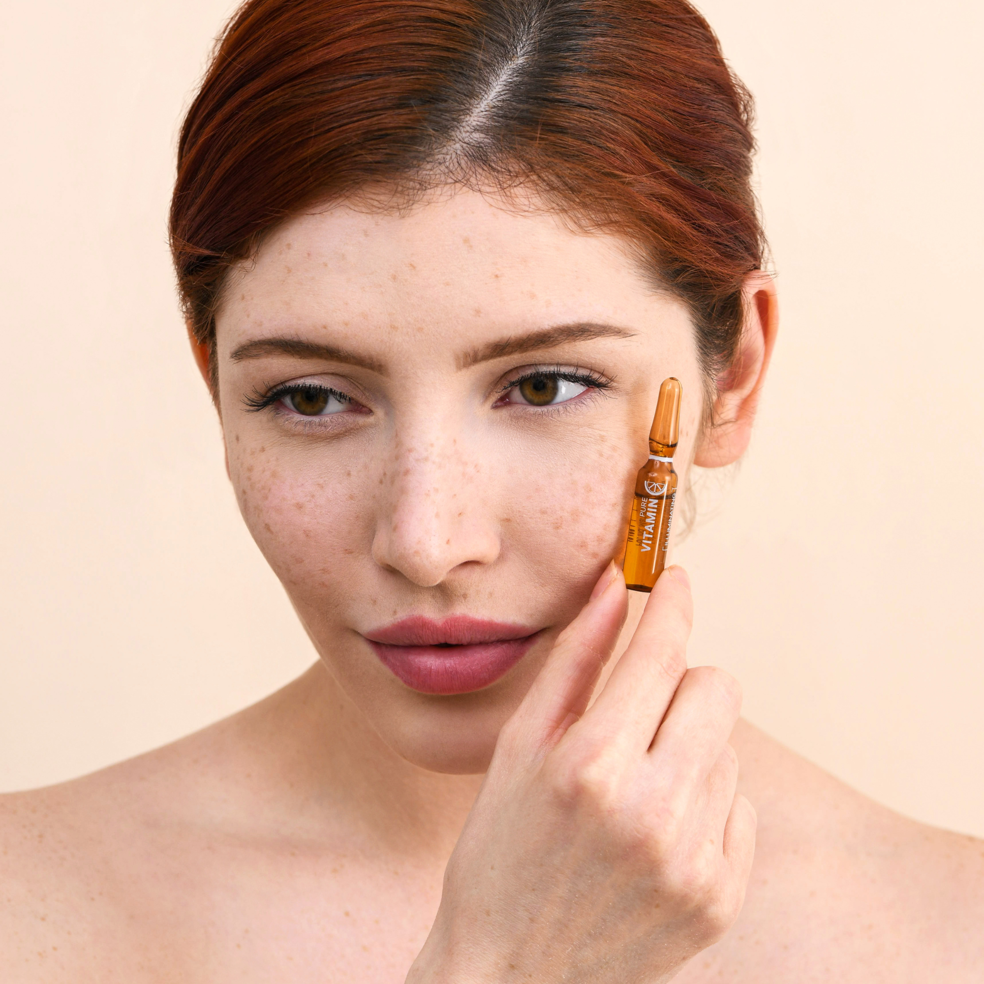 young model holding up Noche's Vitamin C Concentrate.