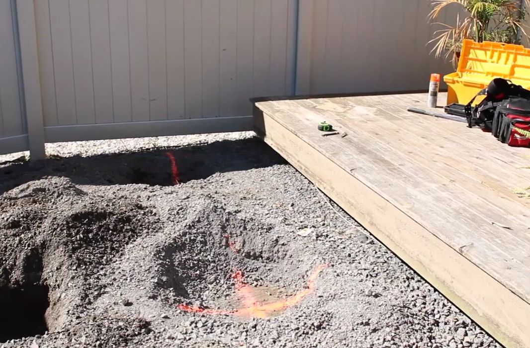 site prepared with gravel over soil before helical piers