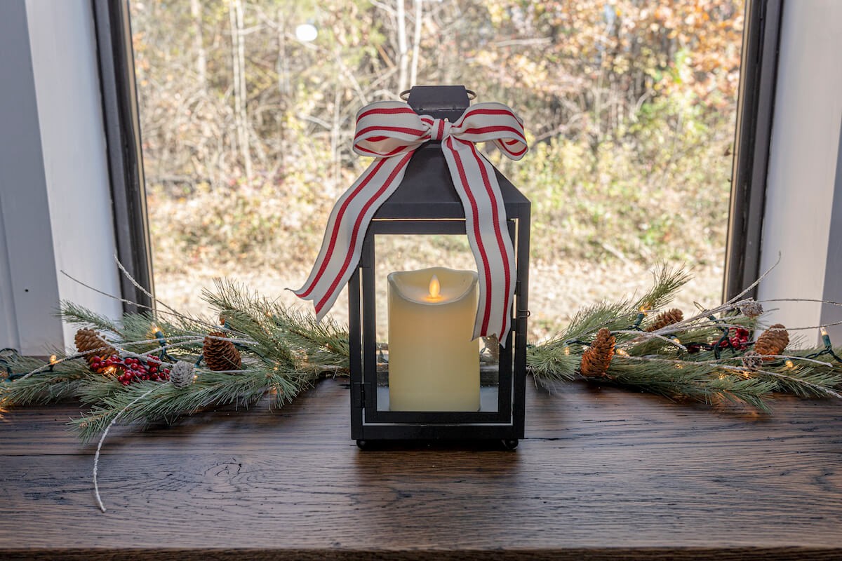 metal lantern with flame free candle and christmas ribbon