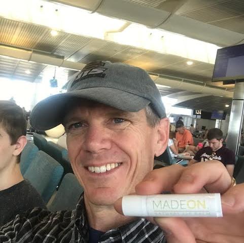 Man holding best lip balm for travel in airport