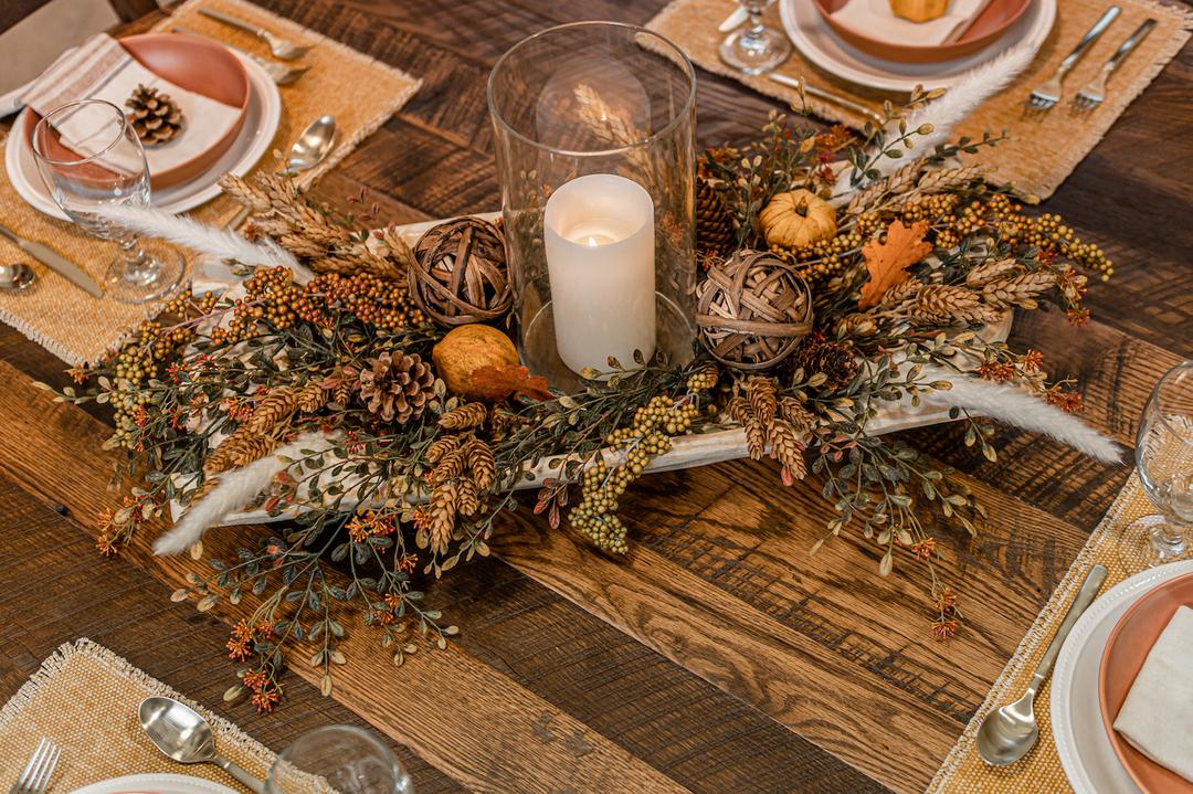 fall centerpiece dough bowl filled with berries, wheat, pinecones, textured pumpkins and leaves