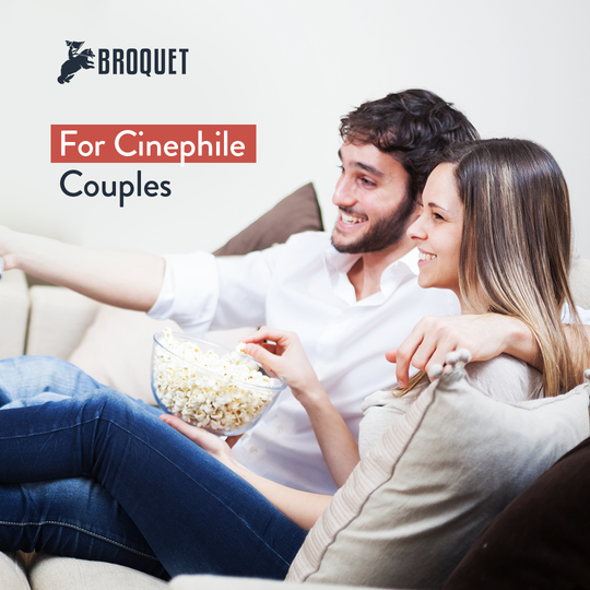 couple in a couch, eating popcorn from a bowl, broquet logo, text reads: For Cinephile Couples