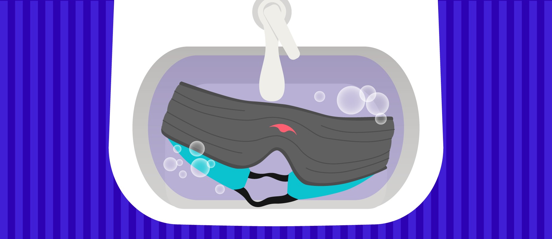 A sink with a gray weighted sleep mask submerged in soapy water.