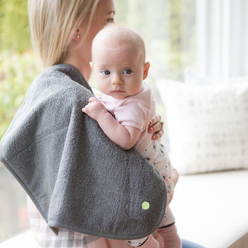 Mum holding a baby with PeapodMat on a shoulder