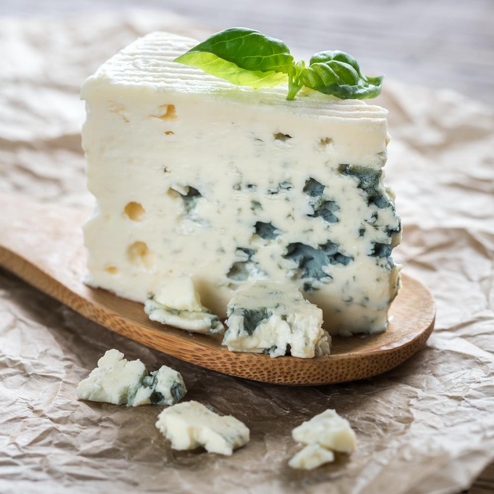 Piece of the blue cheese on the wooden spoon