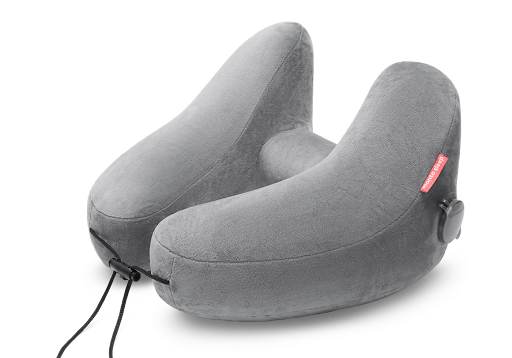 A gray microfleece travel pillow for sleeping on an airplane.