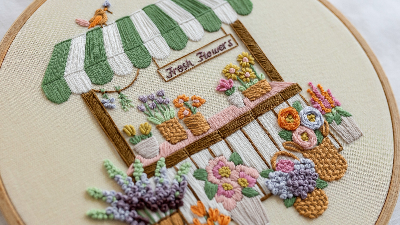 The Flower Stall embroidery pattern, with weave stitch adding texture among the florals.