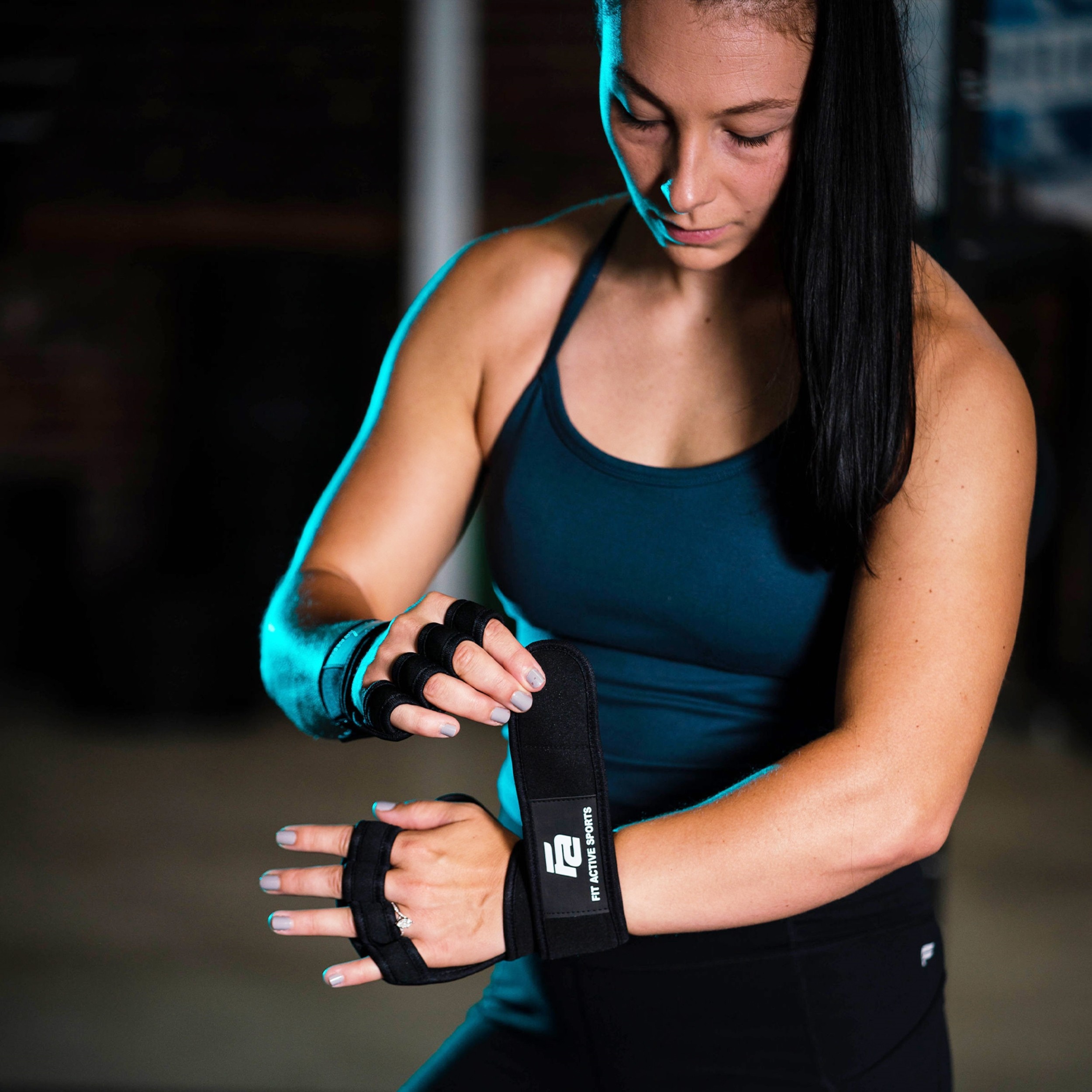 Woman approaching barbell with weights wearing lever belt
