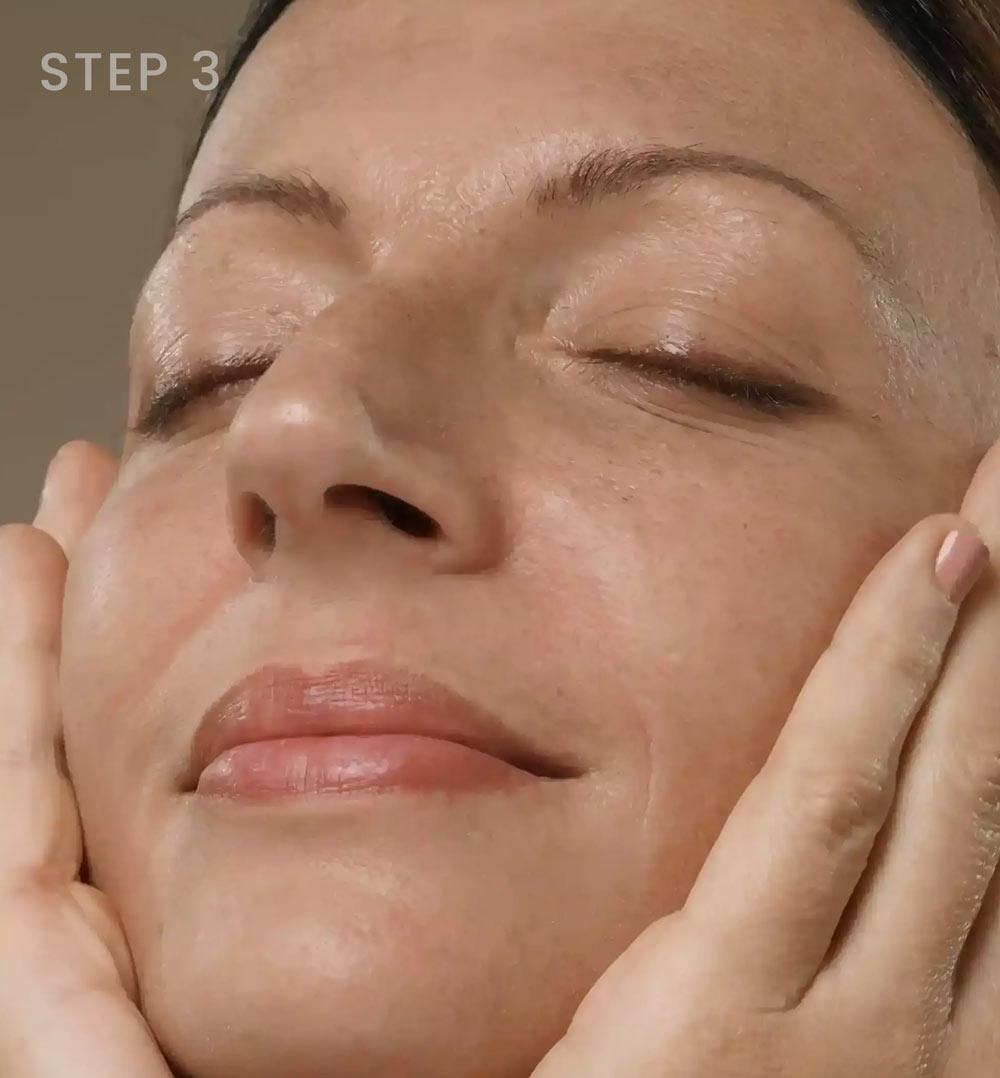 a woman gently massaging her face