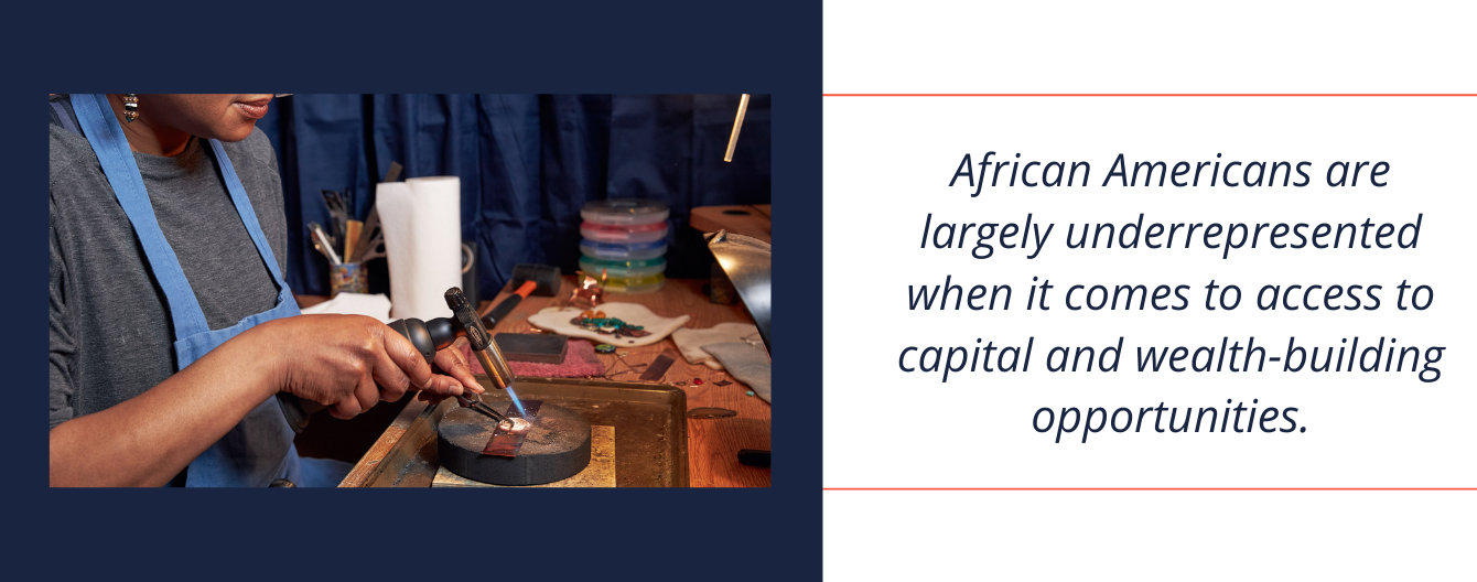 Junebug Jewelry's owner and designer uses a torch to handcraft metal into amazing wearable art jewelry. Next to the photo is text that reads, African Americans are largely underrepresented when it comes to access to capital and wealth-building opportunities.
