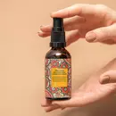Two hands holding a bottle of Prinourish