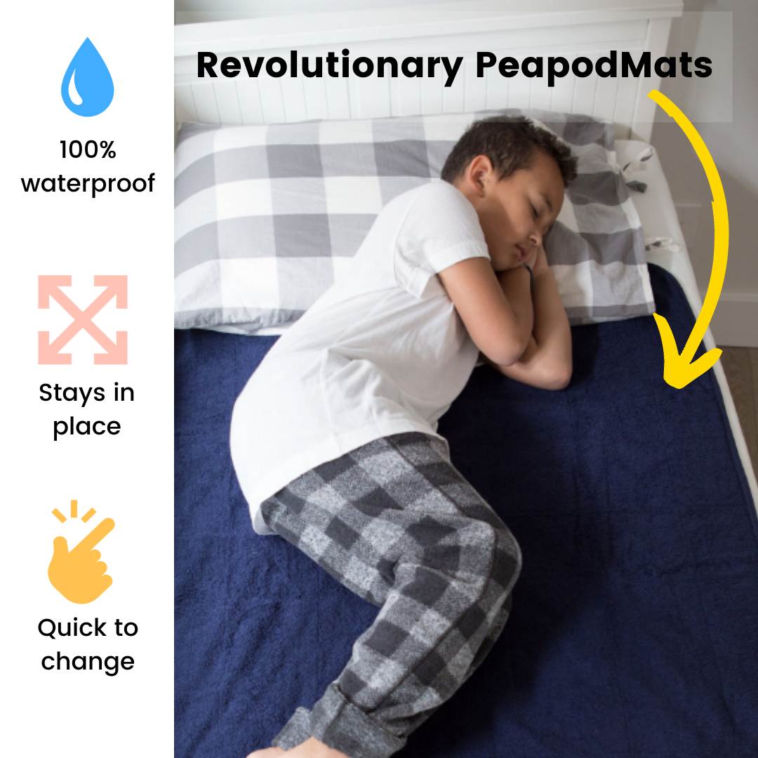 Older boy sleeping on waterproof and washable navy large PeapodMat