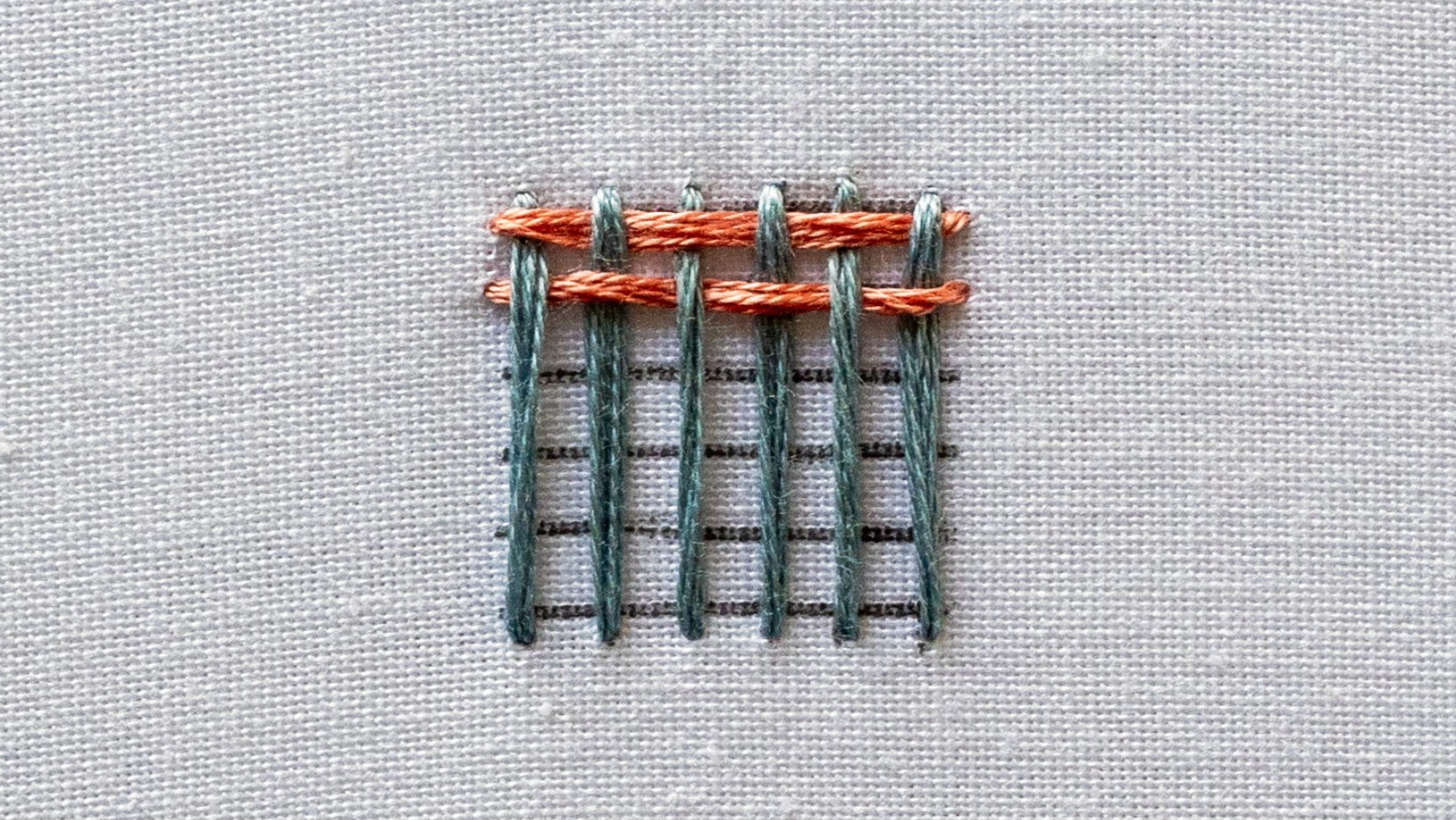 The second row of weaving completed across the warp threads.