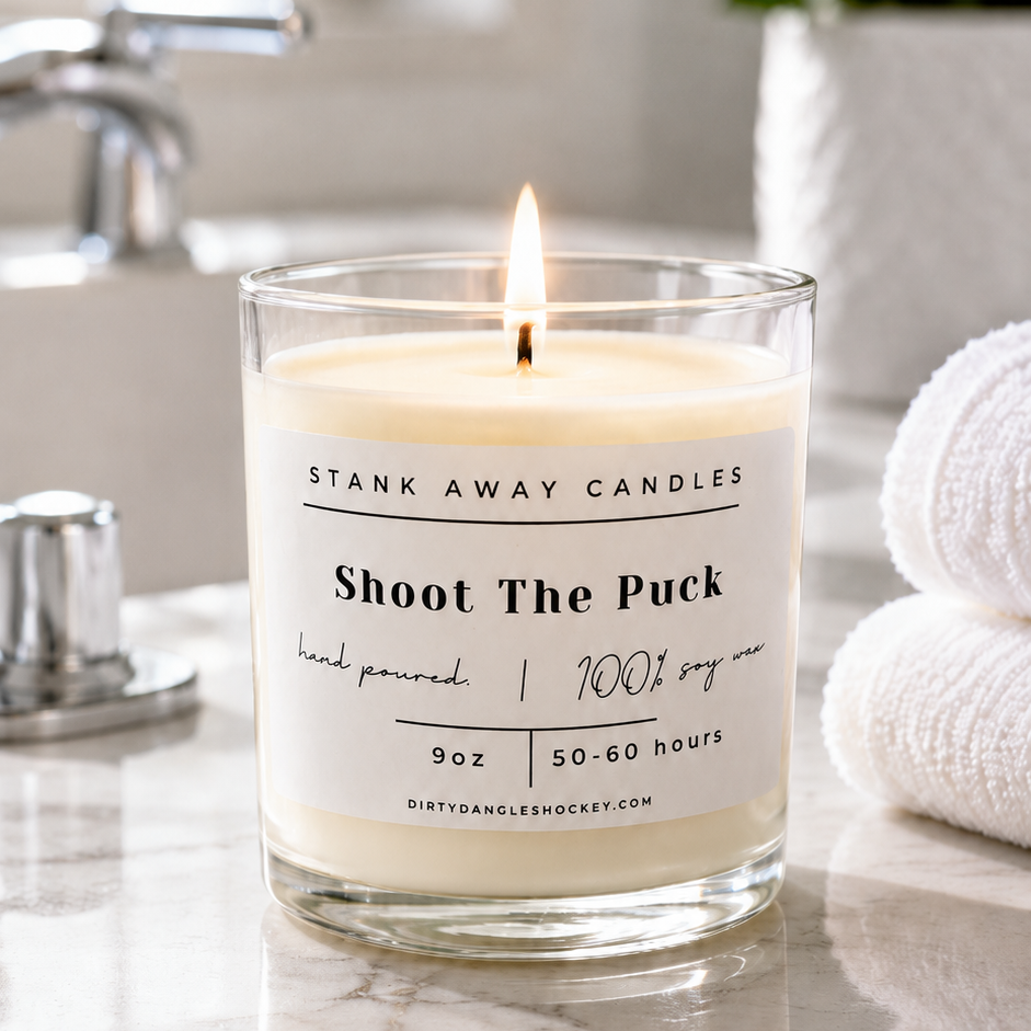 A white scented hockey candle in a bathroom. Shoot the puck